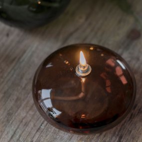 Oljelampa Aura Liten Brun Fra Mette Ditmer - Den djupa bruna f&auml;rgen ger en st&auml;mningsfull k&auml;nsla, och n&auml;r l&aring;gan t&auml;nds sprider lampan ett mjukt, varmt ljus som skapar en avkopplande atmosf&auml;r.