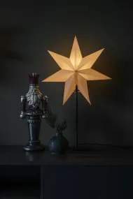Papirstjerne Ø40 Beige Fra Konstsmide - Den stilige stjernen i beige farge hviler p&aring; en flatterende svart metallinnstilling og sprer en myk, behagelig gl&oslash;d.