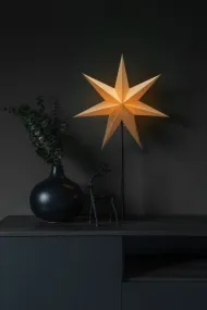 Papirstjerne Ø50 Beige Fra Konstsmide - Den stilige stjernen i beige farge hviler p&aring; en elegant svart metallinnstilling og sprer en myk, behagelig gl&oslash;d.