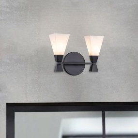 Bowtie 34cm Svart baderomslampe Fra Elstead Lighting - Den mattsvarte Bowtie-vegglampen er et moderne speillys med IP44-klassifisering, noe som gjør den egnet for bad, men også for annet interiør som vaskerom eller gjestetoalett.