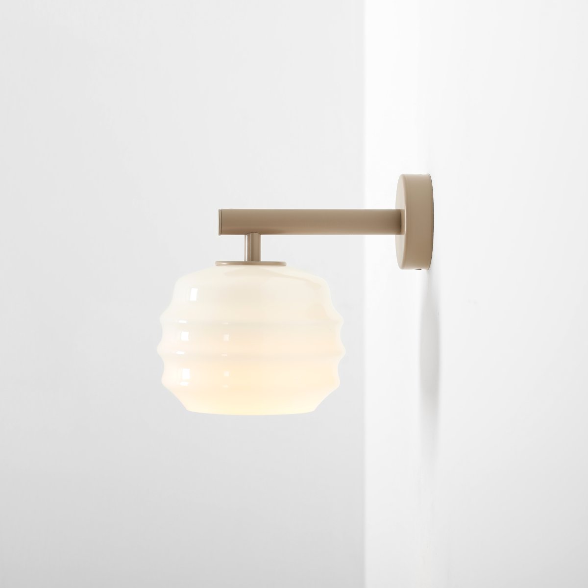 Puff 23cm Beige vegglampe Fra Artera - Den dekorative skjermen i hvitt opalglass har en bølget form som gir lampen et lekent og elegant uttrykk.