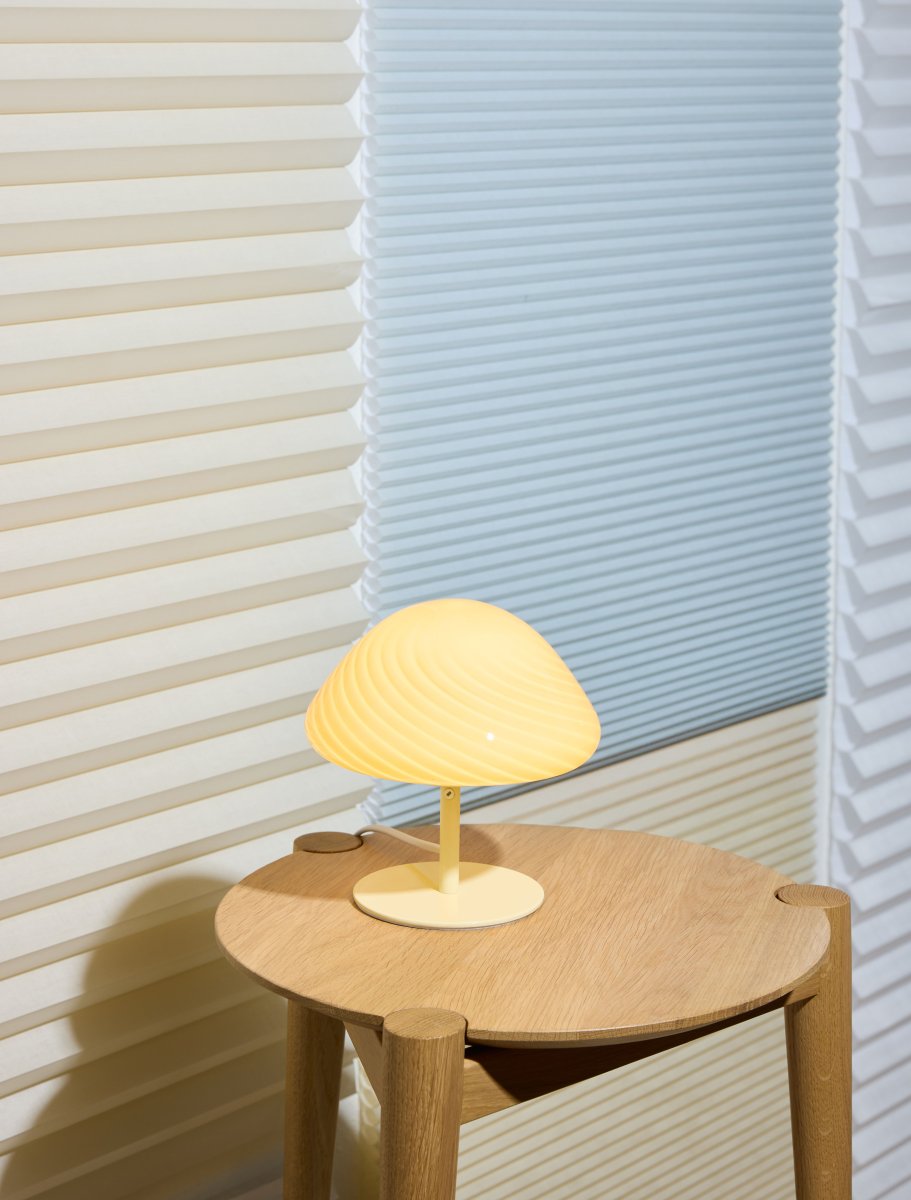 Mini Mush 17cm Krem bordlampe Fra Halo Design - Den unike, b&oslash;lgeformede skjermen gir en myk og behagelig lysspredning, perfekt for &aring; skape en koselig atmosf&aelig;re i ethvert rom.