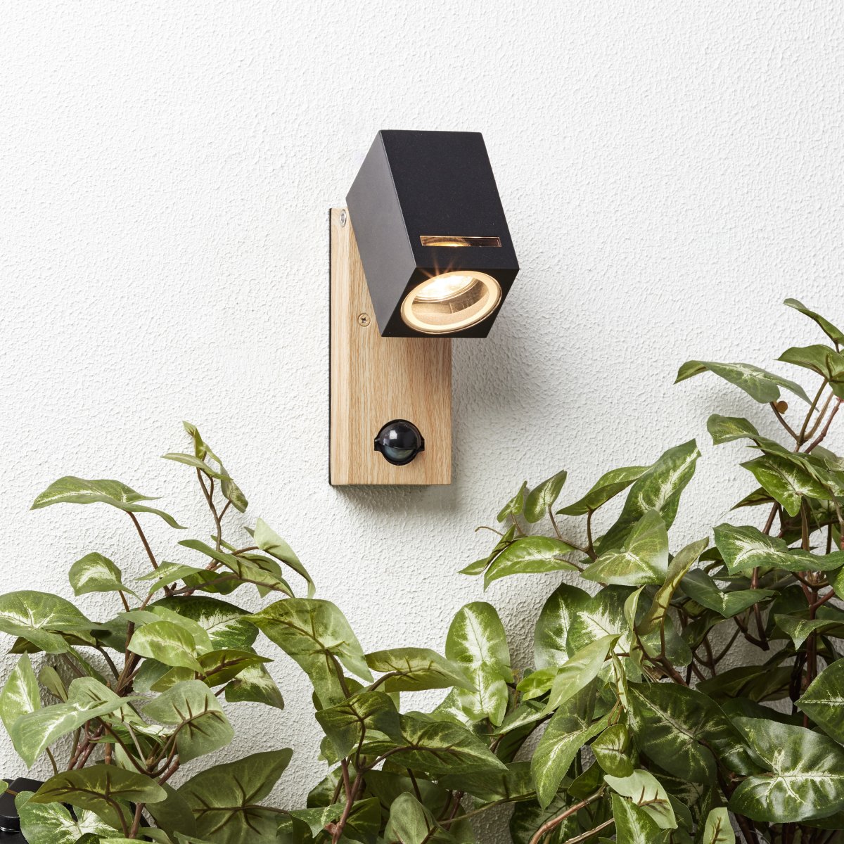 Galeni Natur utendørslampe Fra Brilliant - Den har en justerbar spotlight og en innebygd bevegelsessensor som kan justeres i følsomhet, lys og tid, noe som gjør den både funksjonell og praktisk.