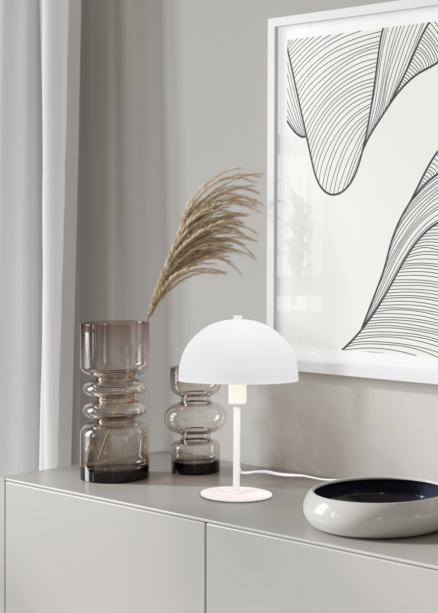 Nola 30cm Hvit bordlampe Fra Trio Lighting - Den moderne, soppformede formen smelter inn i interiøret ditt og skaper harmoni på en byr&aring; eller nattbord.