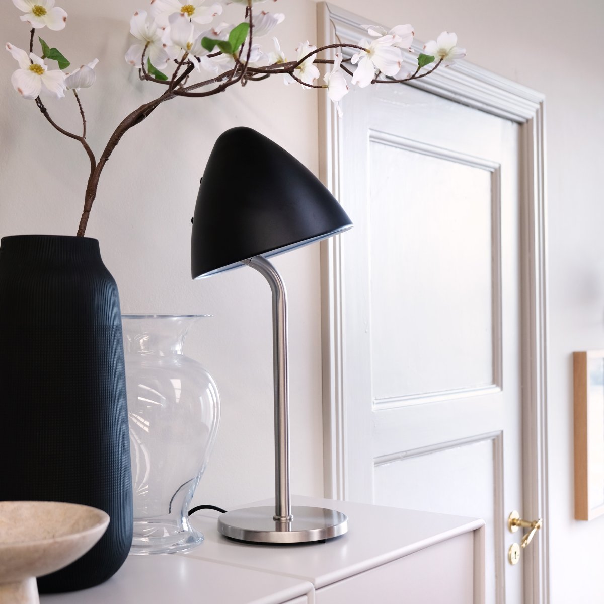 Oulu 47cm Svart bordlampe Fra Dyberg Larsen - Med sin stilige design og kvalitetsmaterialer blir Oulu en iøynefallende detalj som bidrar med eleganse og atmosfære til ditt interiør.