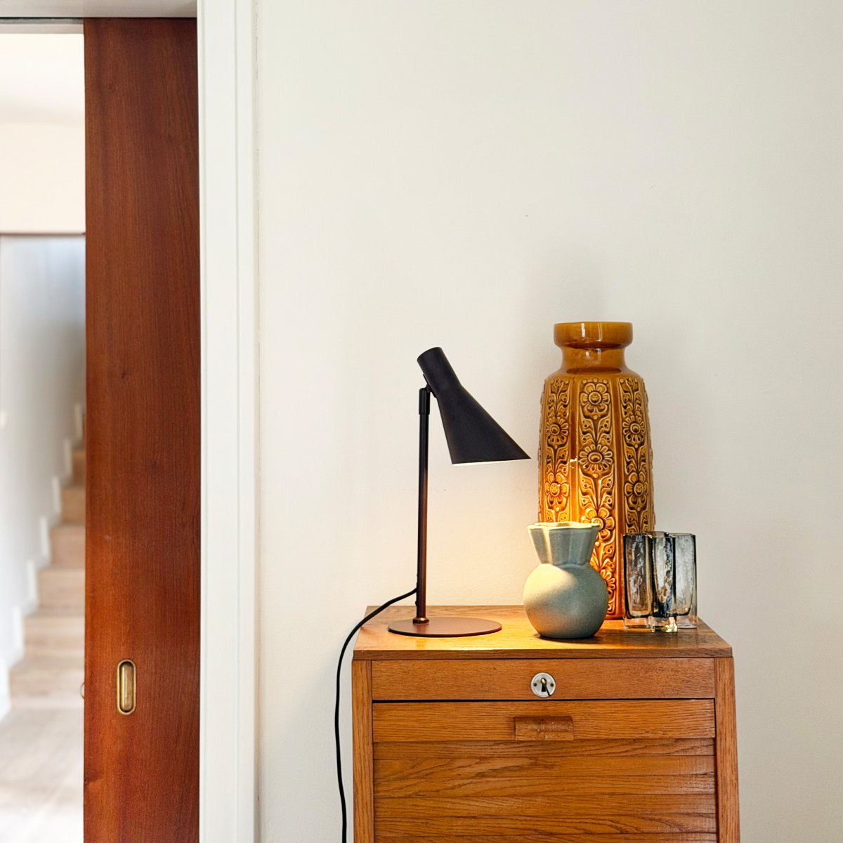 DL12 Mini 40cm Brun skrivebordslampe Fra Dyberg Larsen - Den er utstyrt med en skjerm som kan b&aring;de roteres og vippes, noe som gj&oslash;r det enkelt &aring; rette lyset etter behov.