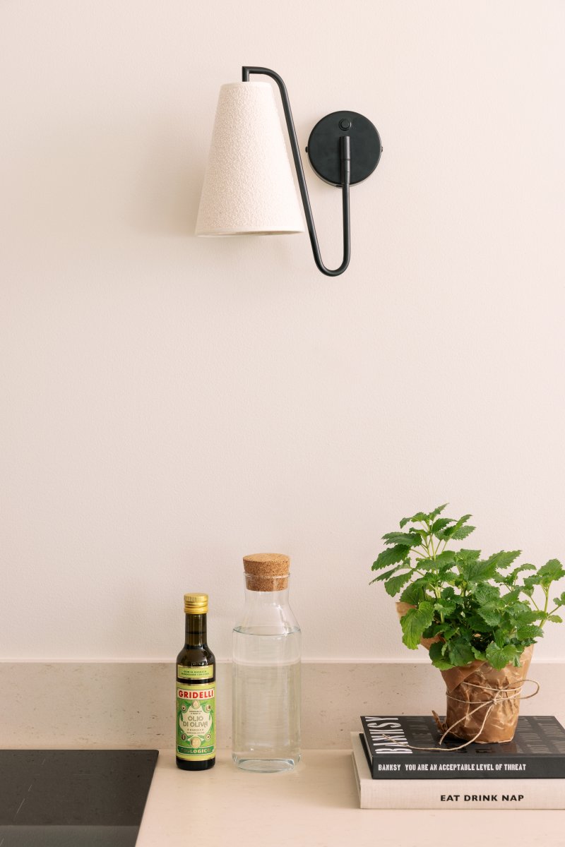 Lou 28cm Svart vegglampe Fra Globen Lighting - Lou er en funksjonell og dekorativ vegglampe med r&oslash;rformet ledd og en lampeskjerm laget av boucl&eacute;-stoff.