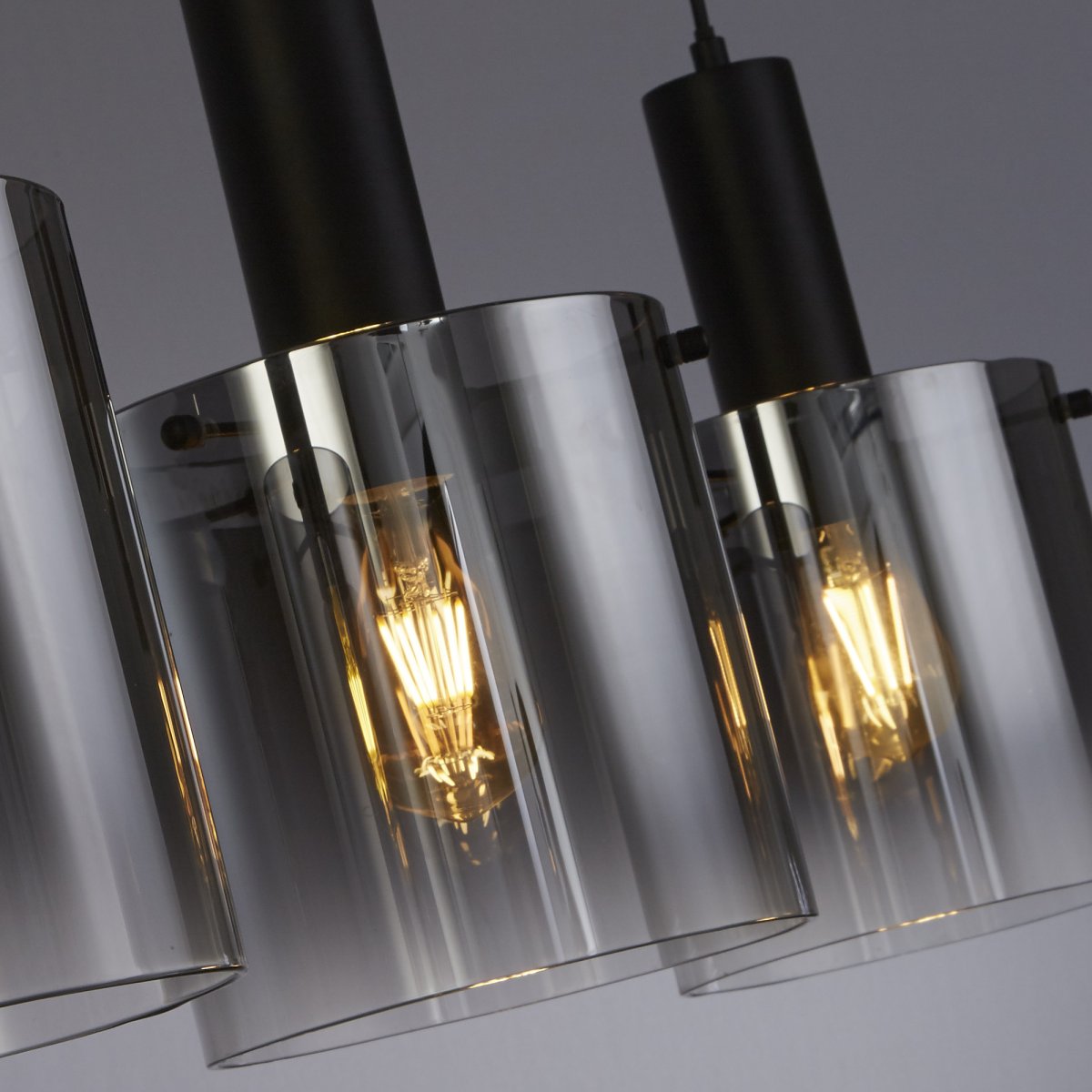 Sweden 142cm Svart Taklampe Fra Searchlight - Sweden er en stilig taklampe med fire sylindriske kupler i svart, lett røkt glass som gir et sofistikert og stemningsfullt lys.