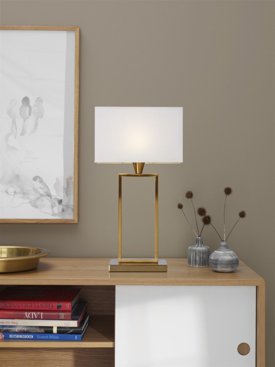Kensington 50cm Messing bordlampe Fra Cottex - Den stilige metallrammen skaper en luftig og moderne følelse, mens den hvite tekstilskyggen sprer et mykt og behagelig lys.