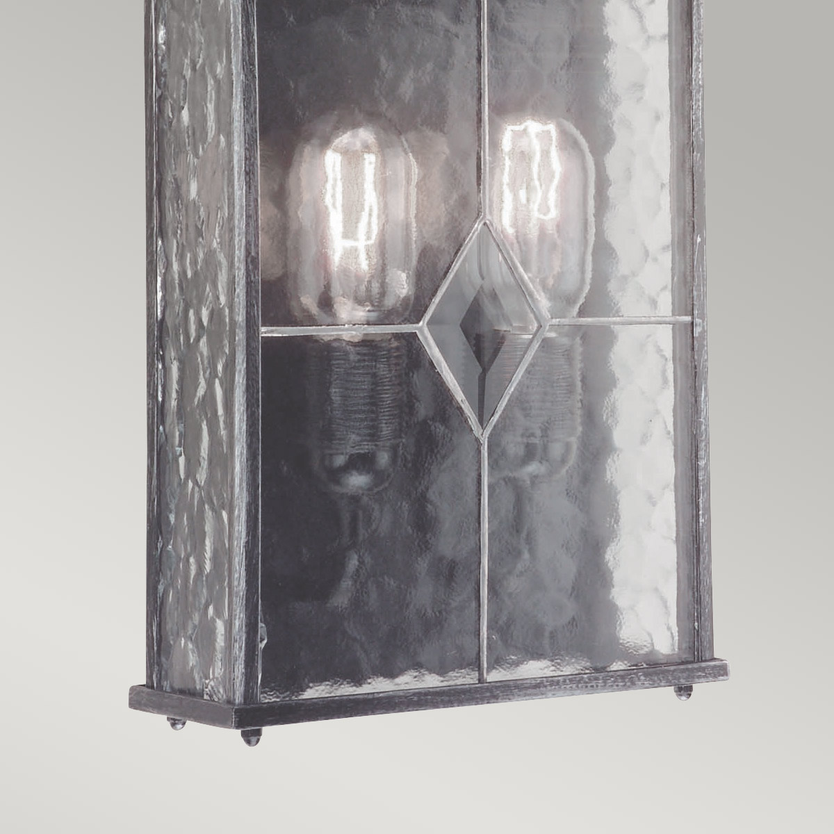 Wexford Sølv utendørslampe Fra Elstead Lighting - Wexford er en klassisk utendørs vegglampe, laget av aluminium med en elegant mørk sølvfinish og dekorative glasspaneler med blyglassmønster.
